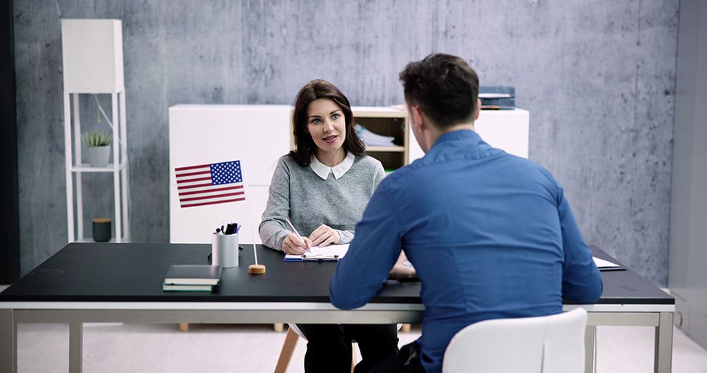 Immigration attorney at desk with a client