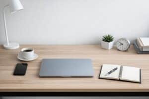 Minimal workspace with closed laptop and notebook representing business computer planning and IT standards